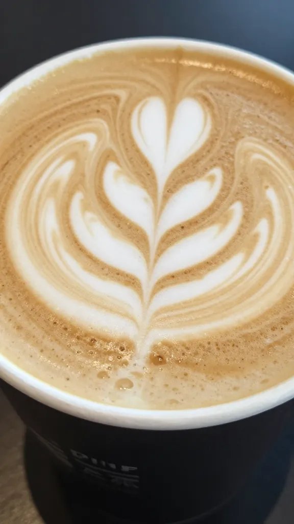 Close-up of a maple pecan latte with latte art on foam