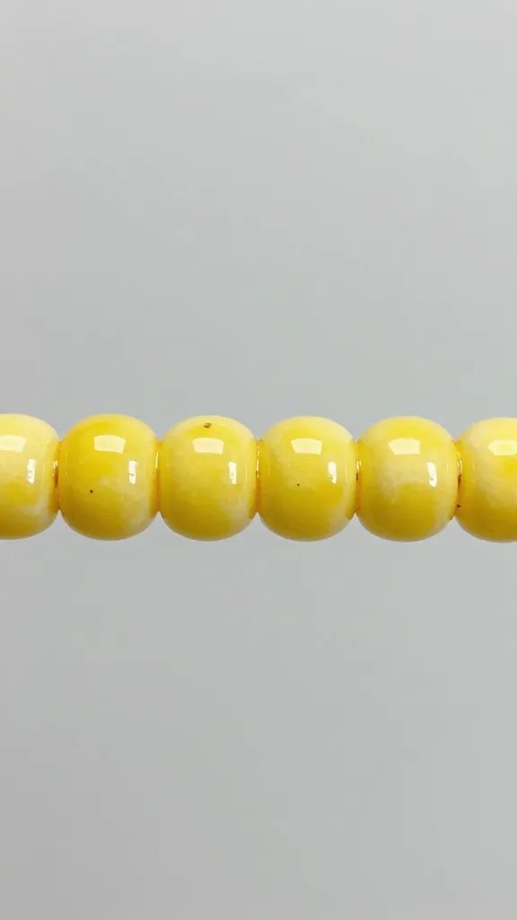 Closeup of glossy lemon glaze bead on bar, minimal background